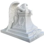 A finely carved white marble sculpture of an angel leaning over a pedestal, showcasing intricate wings and laurel embellishments.