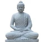 Elegant marble statue of Buddha in a seated meditation pose with intricately carved robe details and serene posture.