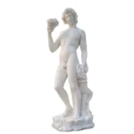 White marble sculpture of a nude male figure holding a cup in one hand and a bundle of grapes in the other on a textured base.