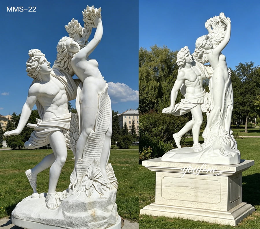 Elegant marble sculpture depicting a couple in dynamic poses, standing on a detailed pedestal in an outdoor park setting.