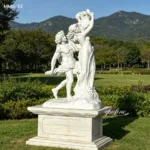 White marble sculpture depicting a couple in a dynamic pose set against a lush green park with mountains in the background.