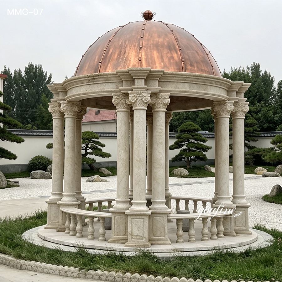 An elegant marble gazebo with ornate columns and a copper dome roof, surrounded by landscaped greenery and rocks.