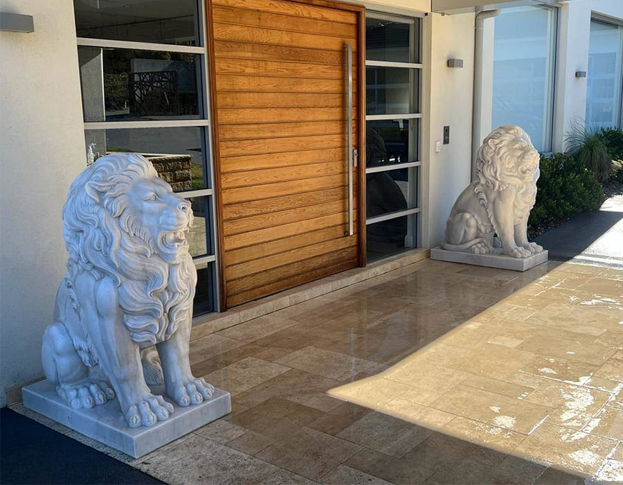 Elegant marble lion statues at modern entryway