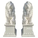 Pair of intricately carved marble lion statues with detailed manes resting on decorative pedestals, ideal for entrance decor.