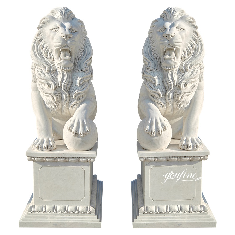 Pair of intricately carved marble lion statues with detailed manes resting on decorative pedestals, ideal for entrance decor.