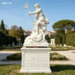 Elegant marble statue of Neptune holding a trident with detailed carving of aquatic elements, displayed in an outdoor garden.