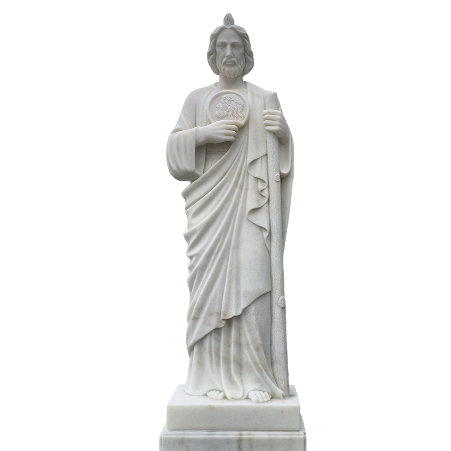 A finely crafted white marble statue of a religious figure holding a staff and medallion, featuring detailed drapery and standing on a pedestal.