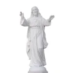 White marble statue of the Sacred Heart with flowing robes and open arms, showcasing detailed carving and religious symbolism.