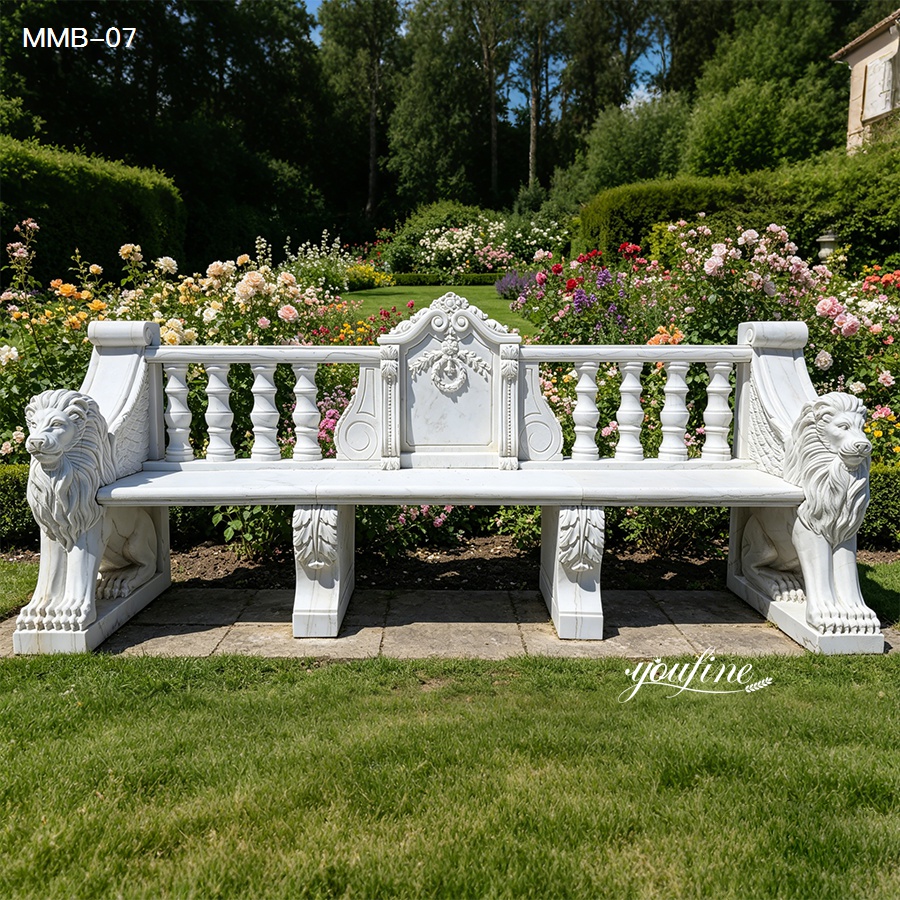 Elegant white marble bench with intricate lion carvings, flanked by lush garden blooms and greenery in a serene outdoor setting.