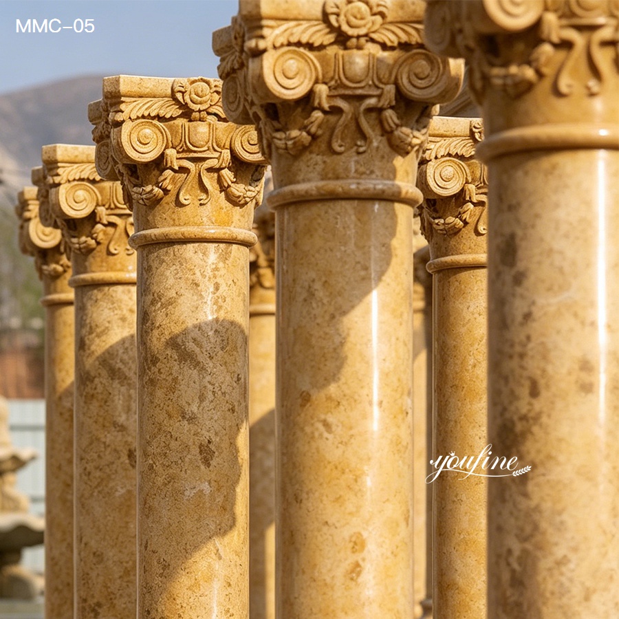 Close-up view of intricately carved marble columns in warm yellow tones, showcasing classical designs and polished surface.