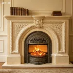 Luxurious marble fireplace with intricate floral and leaf carvings, glowing logs in metal frame, and classic books on top.