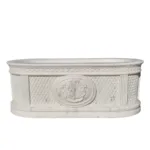 An elegant white marble bathtub featuring intricate lattice patterns, fluted columns, and a central regal crest design, showcasing luxury craftsmanship.