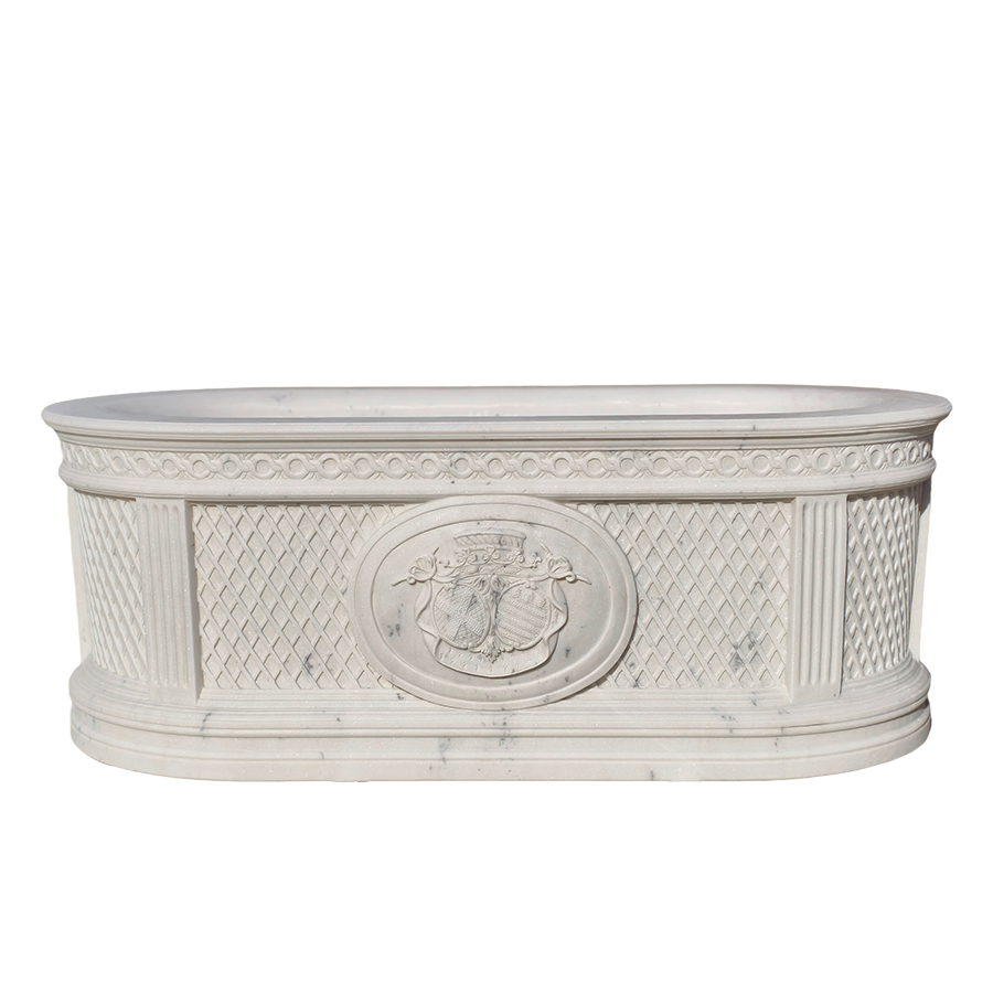 An elegant white marble bathtub featuring intricate lattice patterns, fluted columns, and a central regal crest design, showcasing luxury craftsmanship.
