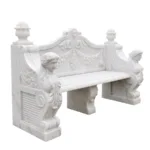 Elegant white marble bench featuring intricate designs, including winged sculptures, floral motifs, and decorative finials.