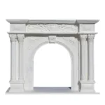 Ornate white marble fireplace featuring intricate floral and scrollwork carvings, flanked by decorative columns.