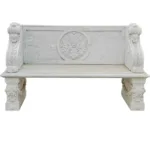 White marble bench featuring intricate floral and ornamental carvings on its backrest and side supports, showcasing craftsmanship.