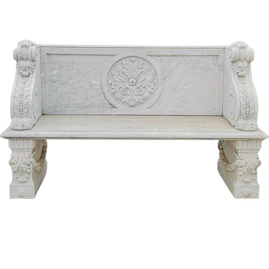 White marble bench featuring intricate floral and ornamental carvings on its backrest and side supports, showcasing craftsmanship.