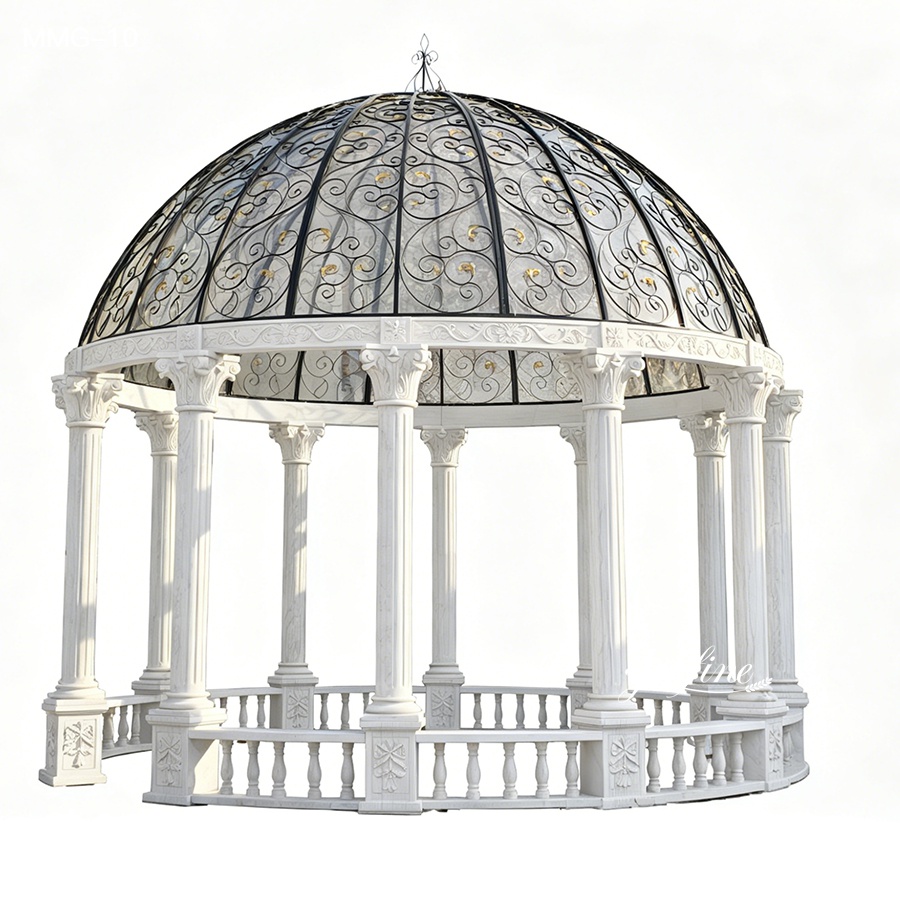 Elegant white marble gazebo with detailed iron dome featuring intricate scrollwork, supported by carved columns and balustrades.