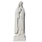 White marble statue of the Virgin Mary in a praying posture, featuring intricate carving details like a rosary and floral motifs.