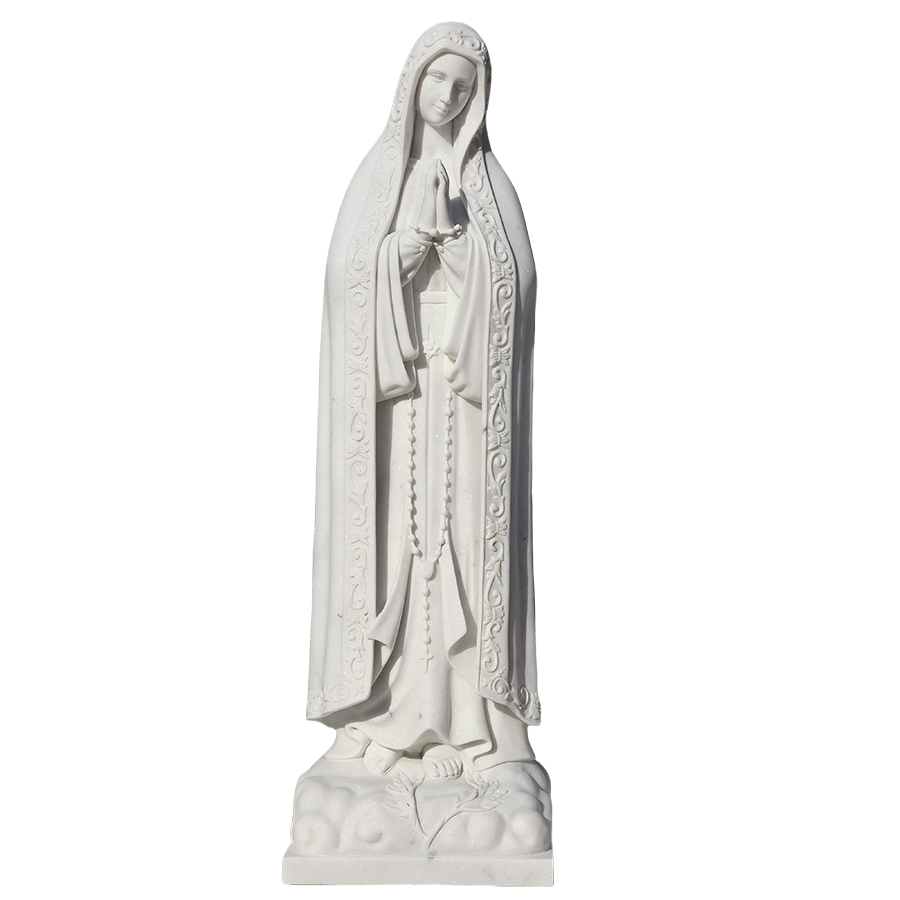White marble statue of the Virgin Mary in a praying posture, featuring intricate carving details like a rosary and floral motifs.