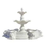 A white marble tiered fountain with intricate carvings, circular basin, and ornamental details, ideal for outdoor decoration.
