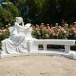 Elegant white marble sculpture of a seated woman reading on a decorative bench, surrounded by vibrant rose bushes in a serene garden.