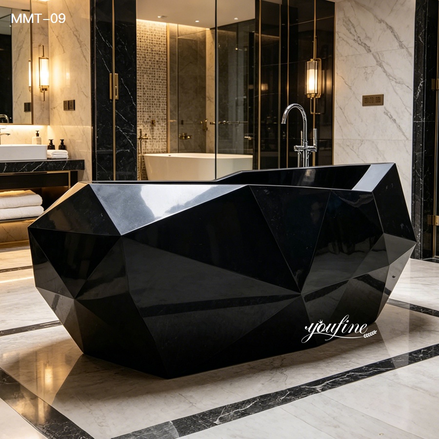 A sleek black geometric marble bathtub with faceted design placed in an elegant modern bathroom featuring marble floors, gold accents, and soft lighting.