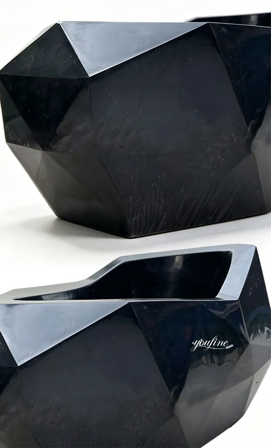 Polished black marble sink with angular geometric design, showcasing a modern and elegant handcrafted style.