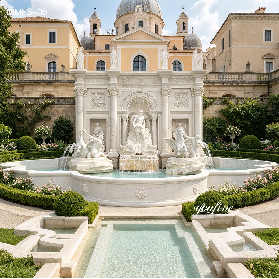 Ornate marble fountain with classical sculptures in a garden setting, backed by a European-style building with a dome.