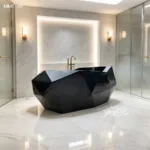 A luxurious black marble bathtub with a faceted design in a modern bathroom featuring white marble walls, gold fixtures, and soft lighting.