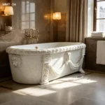 Luxurious white marble bathtub adorned with intricate lion head carvings and draped accents in an elegant bathroom setting.