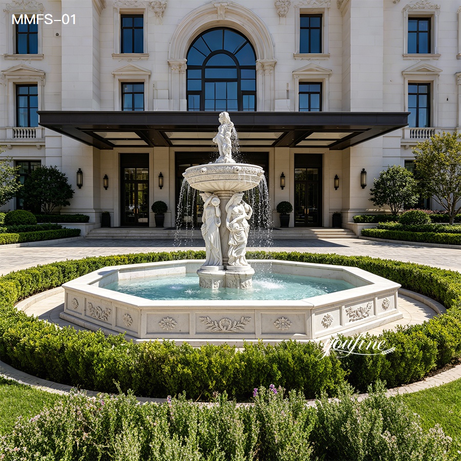 An intricately carved white marble fountain featuring classical figures, placed in the landscaped garden of a luxury mansion entrance.