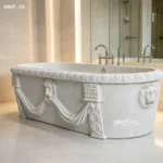 White marble bathtub featuring intricate lion motifs and elegant carvings in a high-end bathroom with soft lighting.