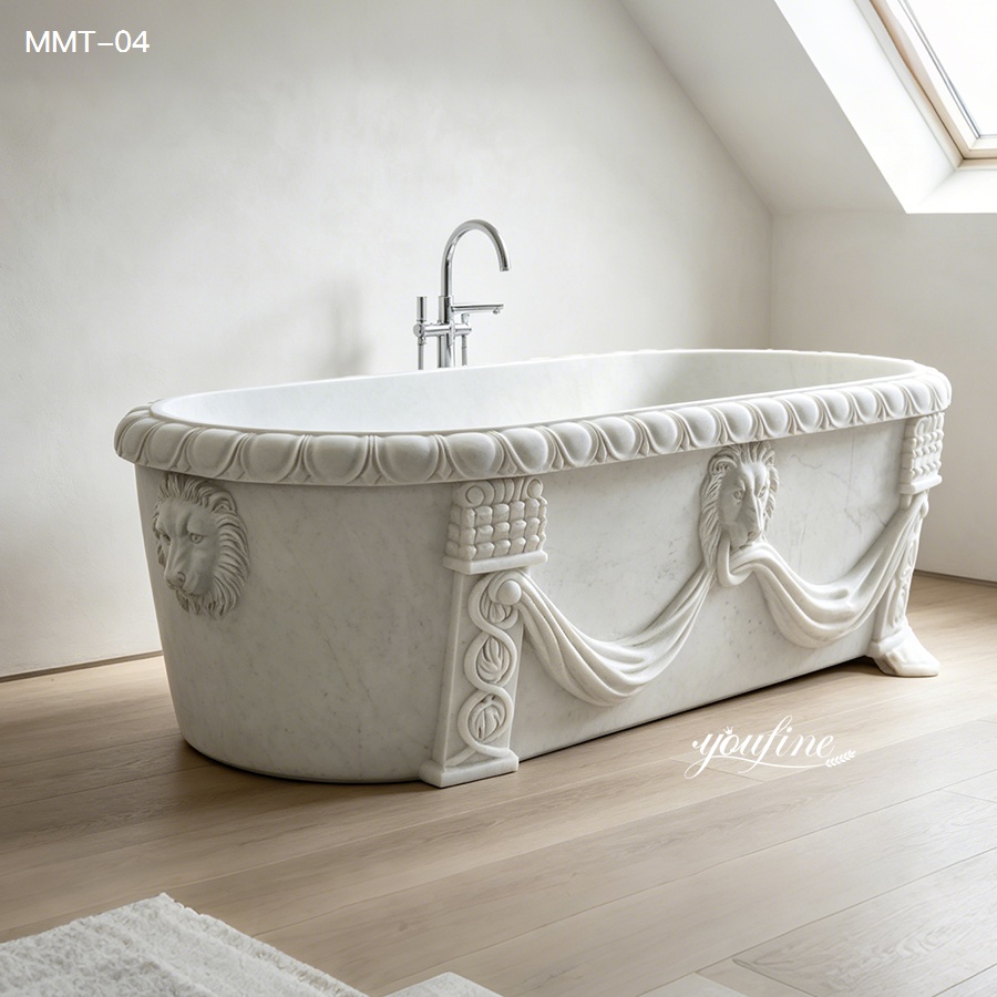 White marble bathtub with intricate lion head ornaments and classical draped detailing, placed in a bright modern bathroom.