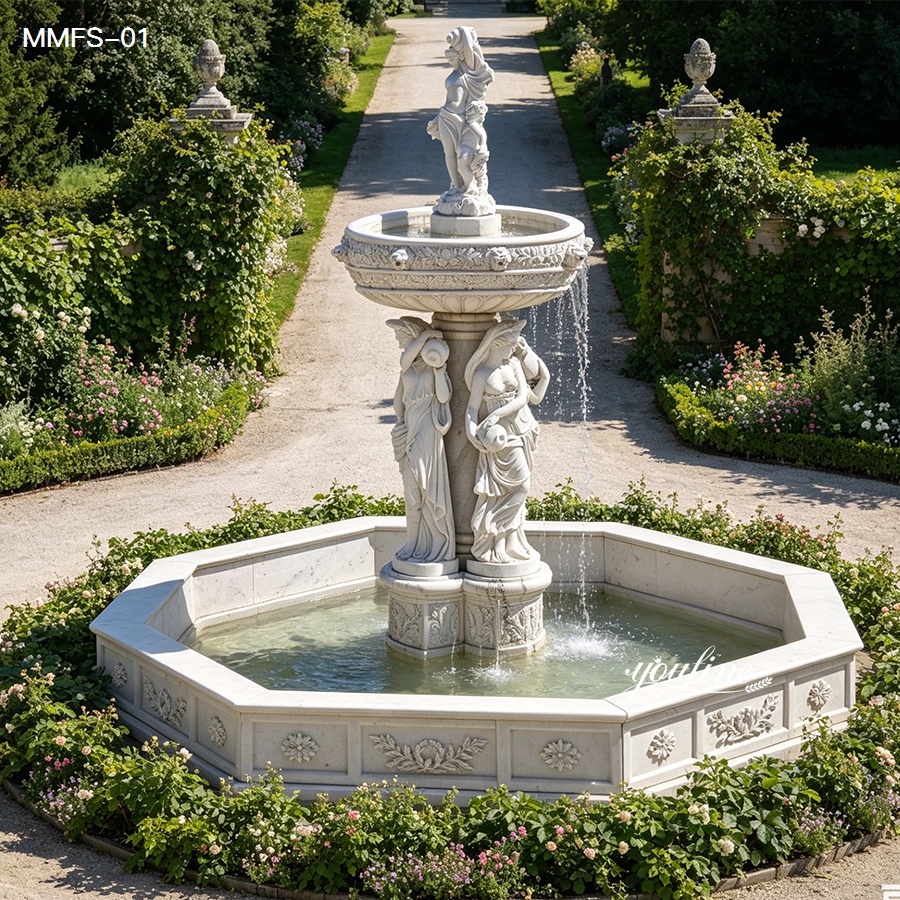 Elegant marble fountain with intricate figure sculptures and flowing water in a lush garden setting surrounded by greenery.