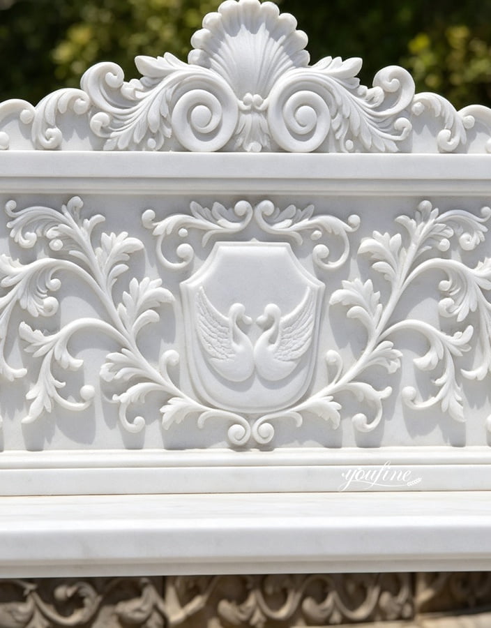 Elegant marble carving with swans and floral details, showcasing exquisite craftsmanship for high-end interiors.