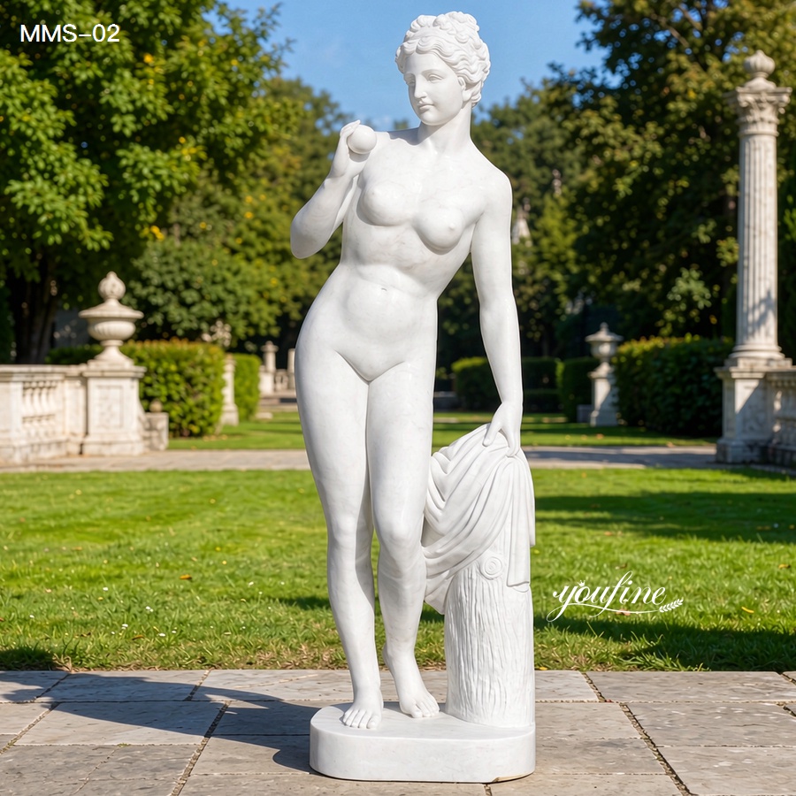 A refined white marble statue of Venus holding an apple and draped over a column, displayed in a bright, landscaped garden.