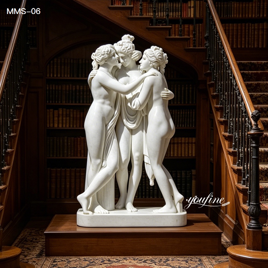 White marble sculpture of the Three Graces, showcasing detailed craftsmanship, placed between wooden staircases in an elegant library.