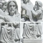 Close-up of a white marble sculpture depicting Jesus with children, showcasing intricate details of the design and expressions.