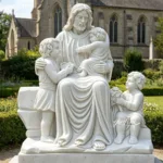 Elegant white marble sculpture depicting Jesus seated with three children in a garden, with a historic church in the background.