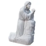 Elegant marble sculpture of Jesus Christ kneeling on a rock with hands clasped in prayer, showcasing serene craftsmanship.