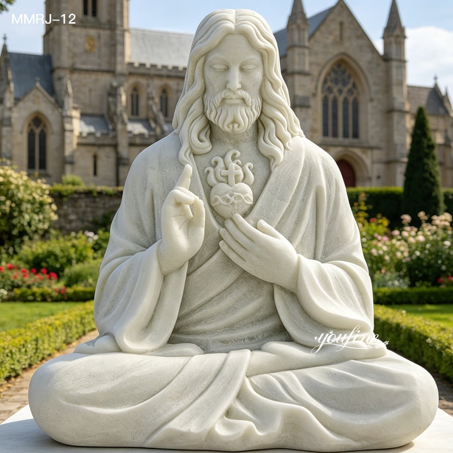 A marble statue of Jesus with the Sacred Heart symbol, seated in a garden setting in front of a Gothic-style church.