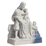 White marble statue of Jesus seated with children around Him in a compassionate and nurturing pose.