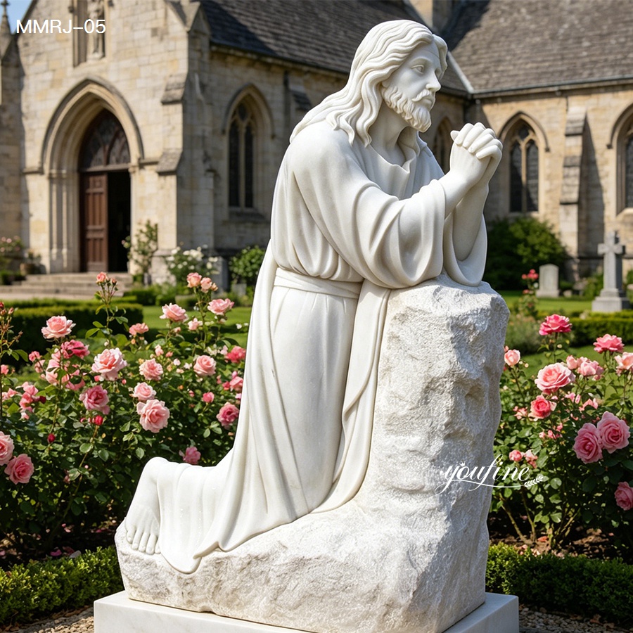 Marble statue of Jesus praying on a stone in a serene rose garden with a church in the background, showcasing exquisite carving details.