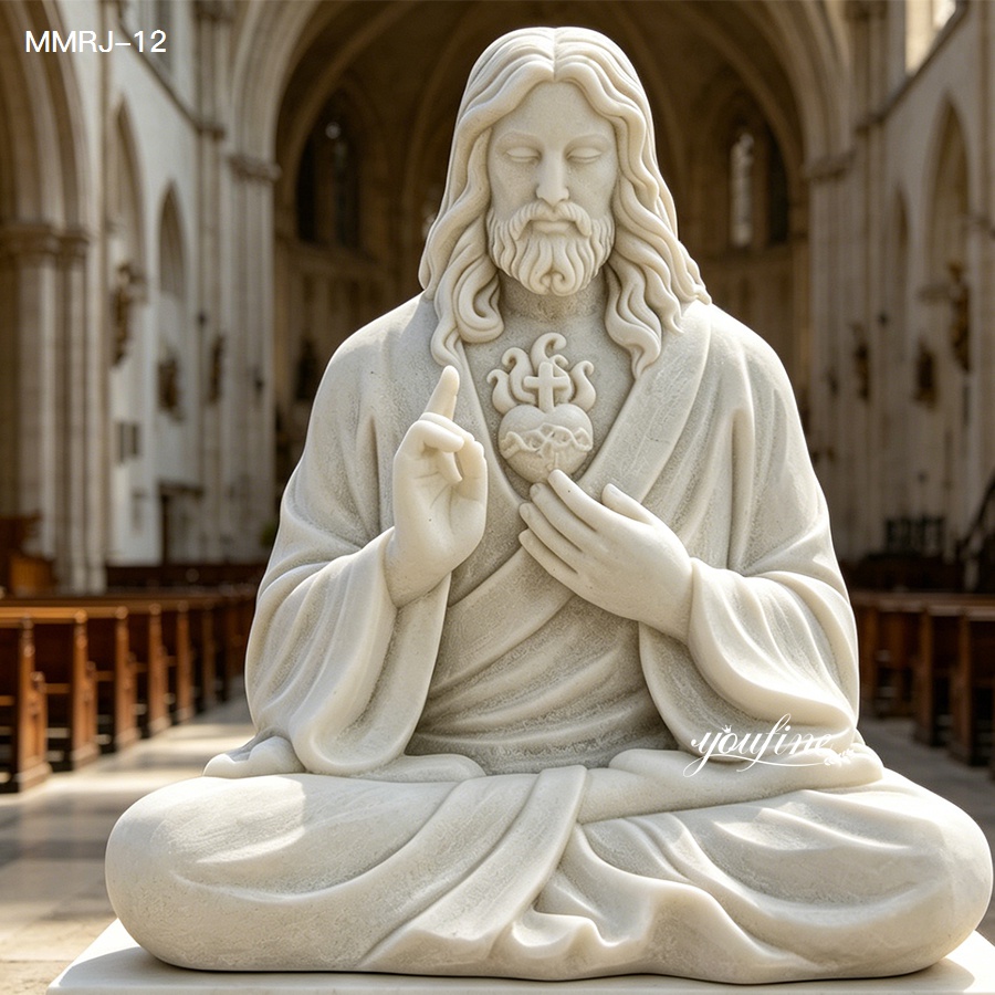 Beautiful white marble sculpture of the Sacred Heart of Jesus with intricate details, seated in meditation inside a church.