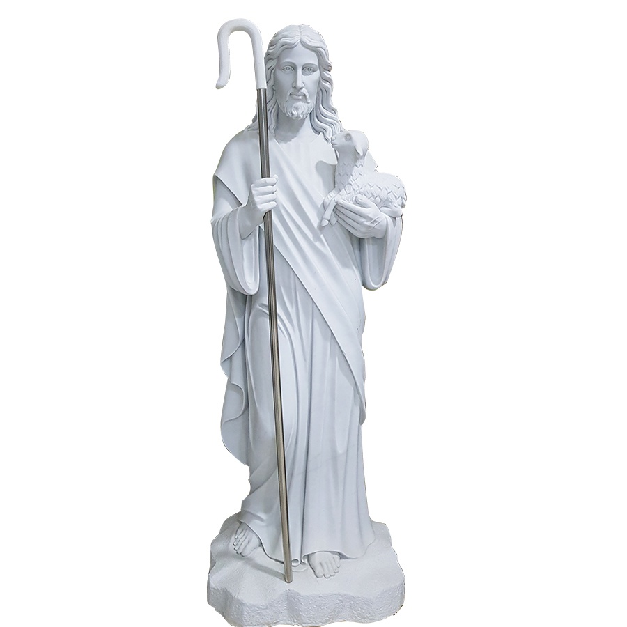 White marble sculpture of Jesus depicted as the Good Shepherd holding a lamb and a shepherd’s staff, symbolizing care and guidance.