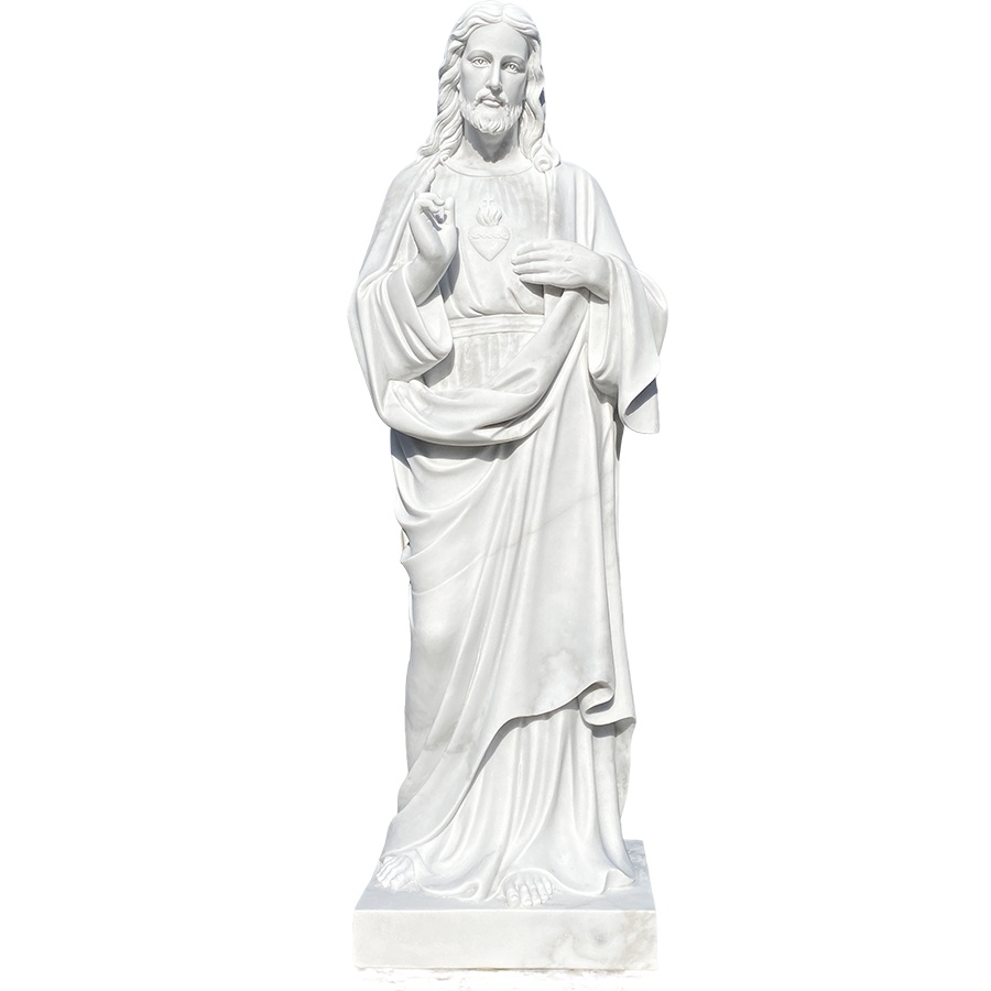 White marble statue of the Sacred Heart of Jesus, featuring intricate detailing and a serene expression, standing on a pedestal.