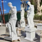 A finely crafted marble sculpture inspired by Venus de Milo, displayed outdoors on a pedestal against a sunny background.
