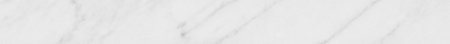 White marble surface with soft gray veins in a subtle, polished texture.